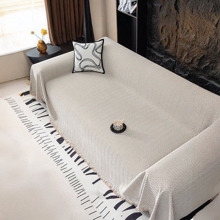 Versatile chenille throw blanket with fringe, suitable as a herringbone sofa cover.
