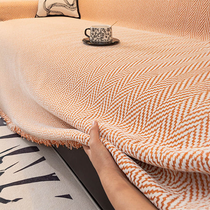 Chic herringbone design chenille sofa throw with fringe, for enhanced living spaces.