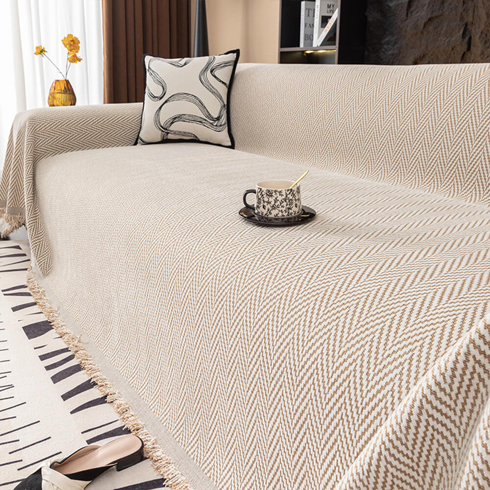 Soft chenille herringbone couch cover with fringe, protects sofa and adds style.