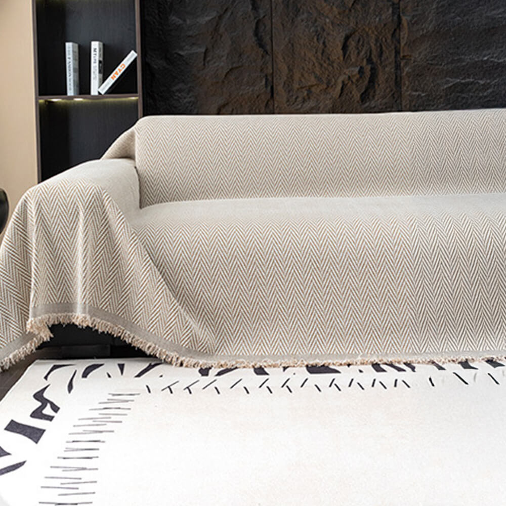 Elegant chenille herringbone sofa cover with fringe, perfect for home decor.