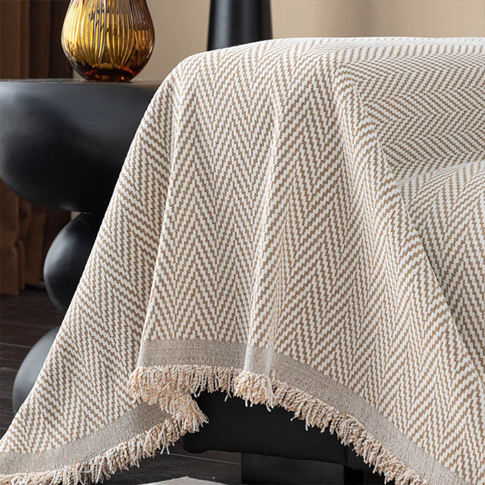 Cozy non-slip chenille herringbone sofa throw with fringe, enhances living room.