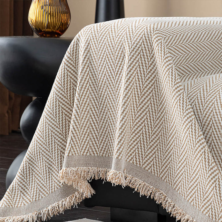 Cozy non-slip chenille herringbone sofa throw with fringe, enhances living room.