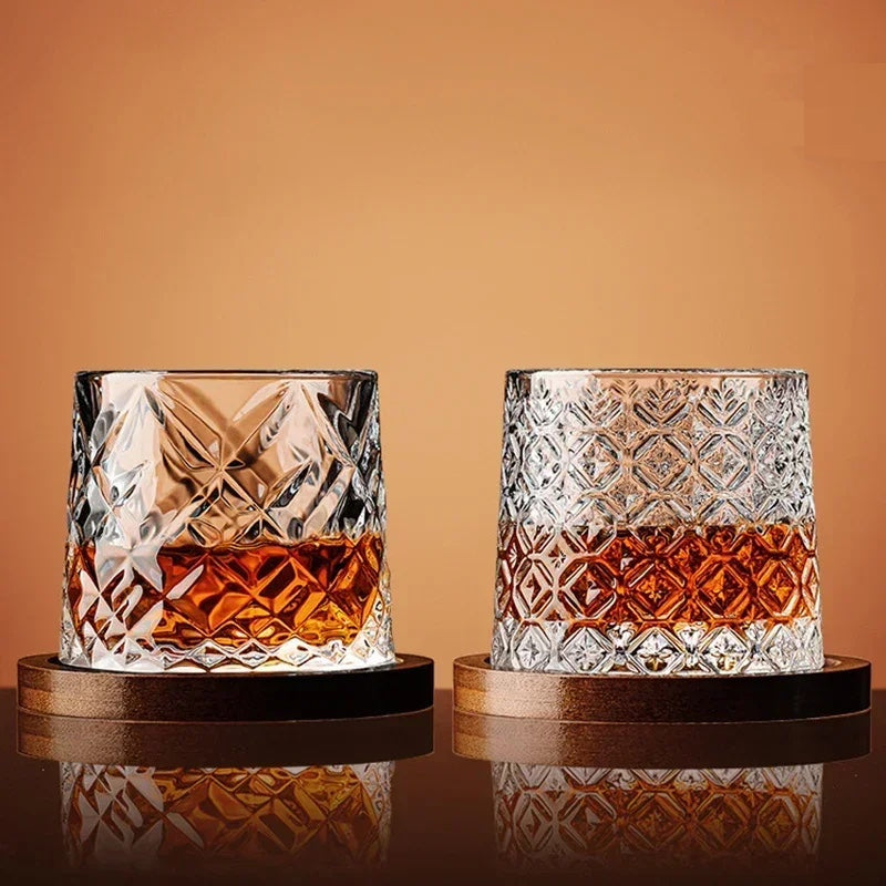 A hand holding a premium crystal whiskey glass filled with amber spirits. Elegant barware experience.