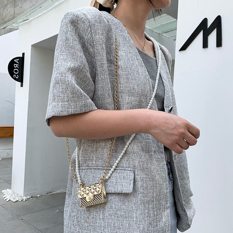 Dazzling mini rhinestone women's purse, a versatile gold or silver accessory for evening outfits.