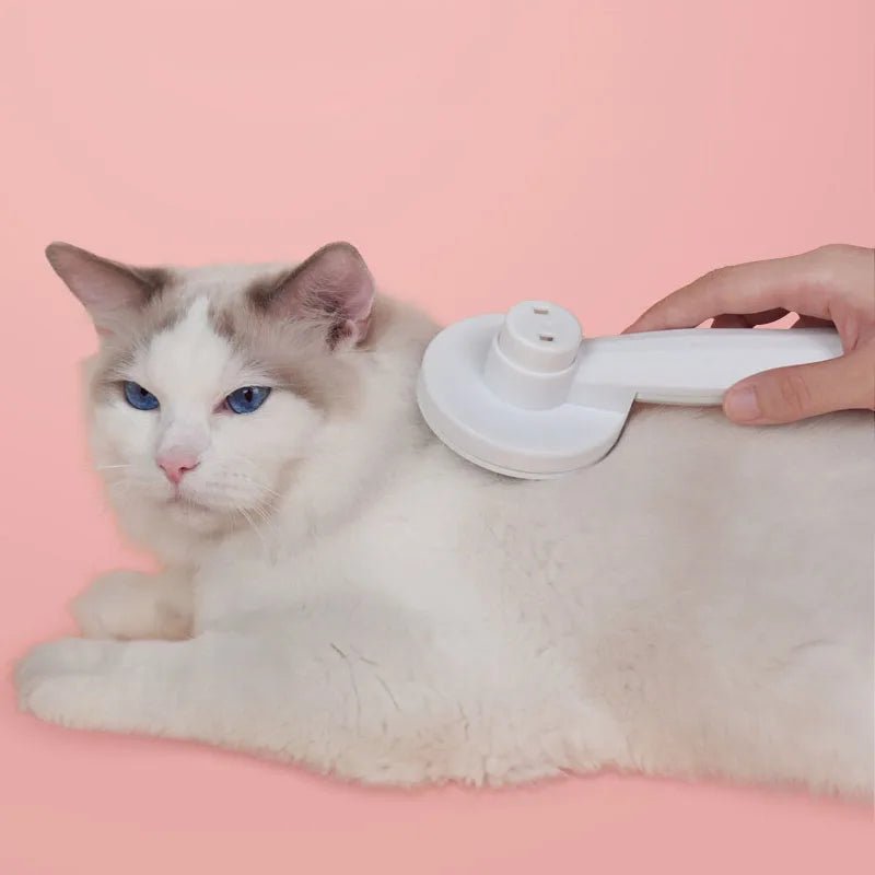 Grooming brush for pets, suitable for cats and dogs of all sizes, with an easy-clean button for convenience.
