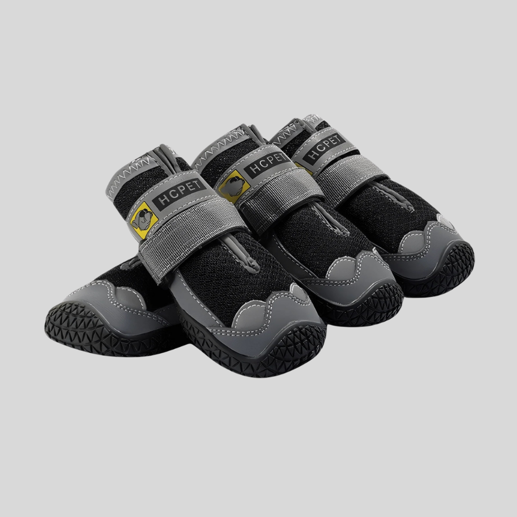 Pair of water-resistant dog boots with adjustable straps, offering paw protection for pets.