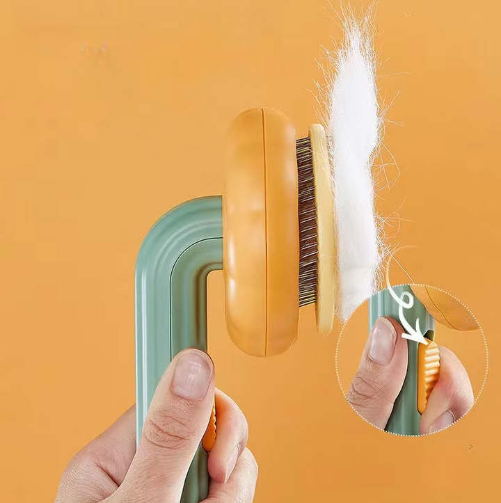 Grooming tool: orange pumpkin style brush, efficiently gathers cat fur