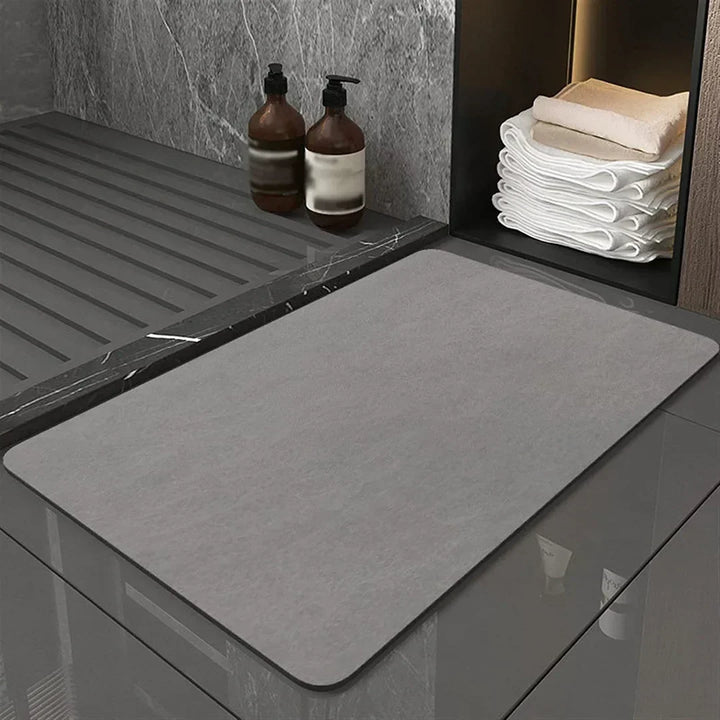 Absorbent diatomite bath mat, quick-drying & anti-slip for safe bathroom use. Modern floor mat.