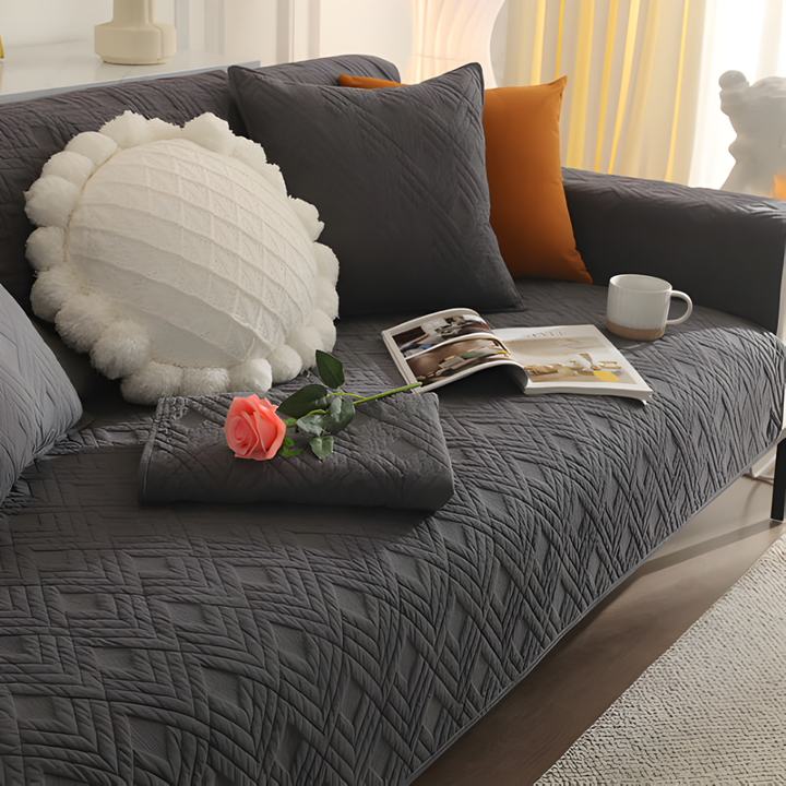 Elegant quilted sofa slipcover for sectional, featuring anti-slip backing for pet-friendly homes