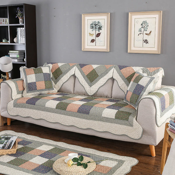 Non-slip quilted couch cover in durable cotton blend, washable, protecting sofa in a living room.