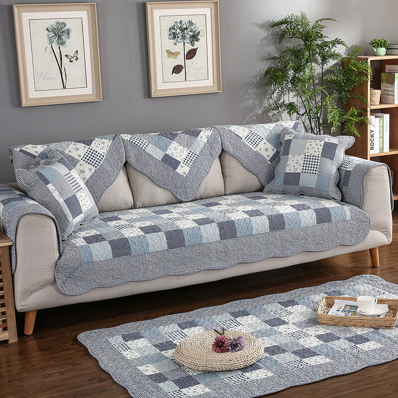 Breathable cotton sofa protector, quilted pattern, non-slip backing, washable for easy care.
