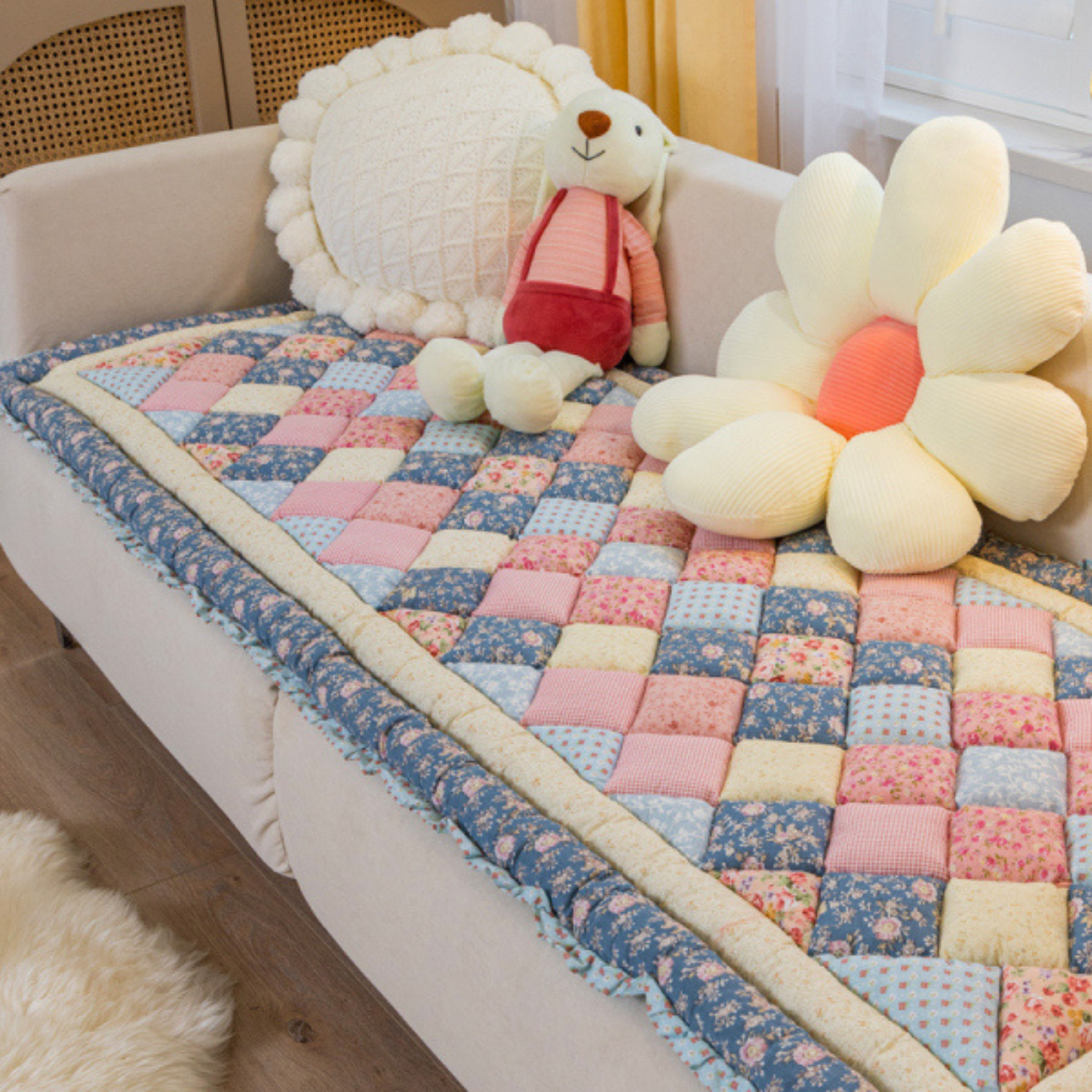 Non-slip sofa couch cover protector with an intricate quilted floral design, ideal for furniture protection.