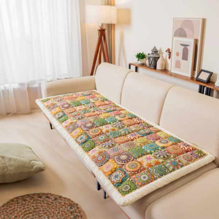 Back view of a non-slip quilted floral sofa cover, highlighting its secure fit and furniture protection.
