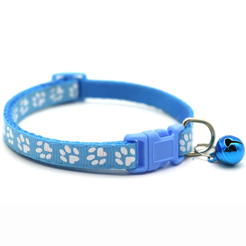 Small dog wearing a red adjustable bowtie collar with bell, showcasing a cute and stylish pet accessory.