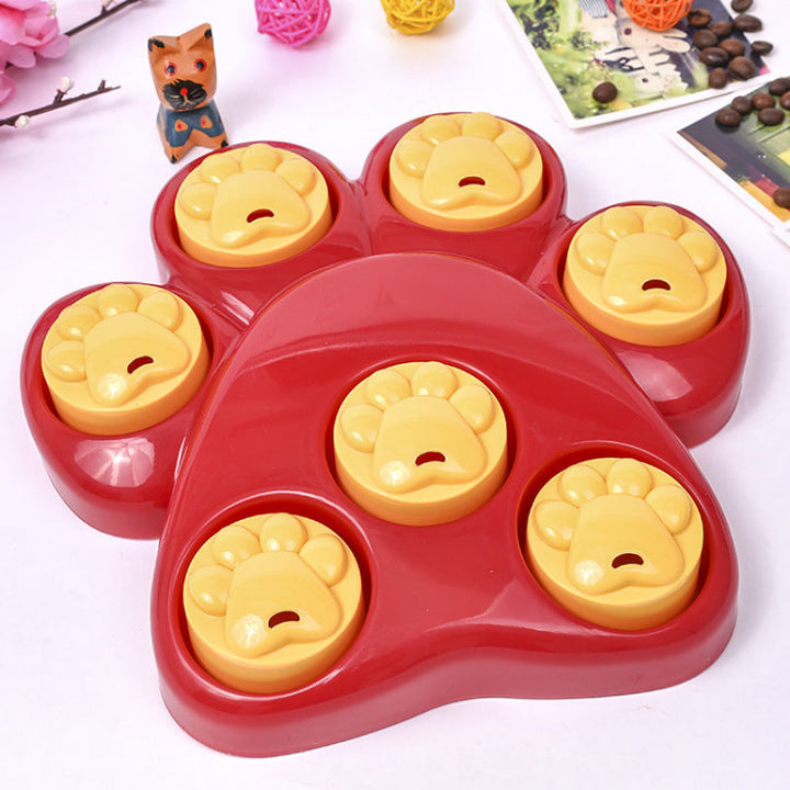 Close-up of a red dog paw puzzle feeder toy, perfect for dog enrichment and slow feeding