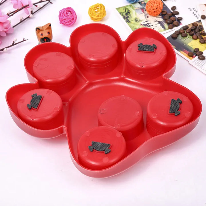 Interactive dog feeder toy with a paw print design in red, offering mental stimulation for dogs