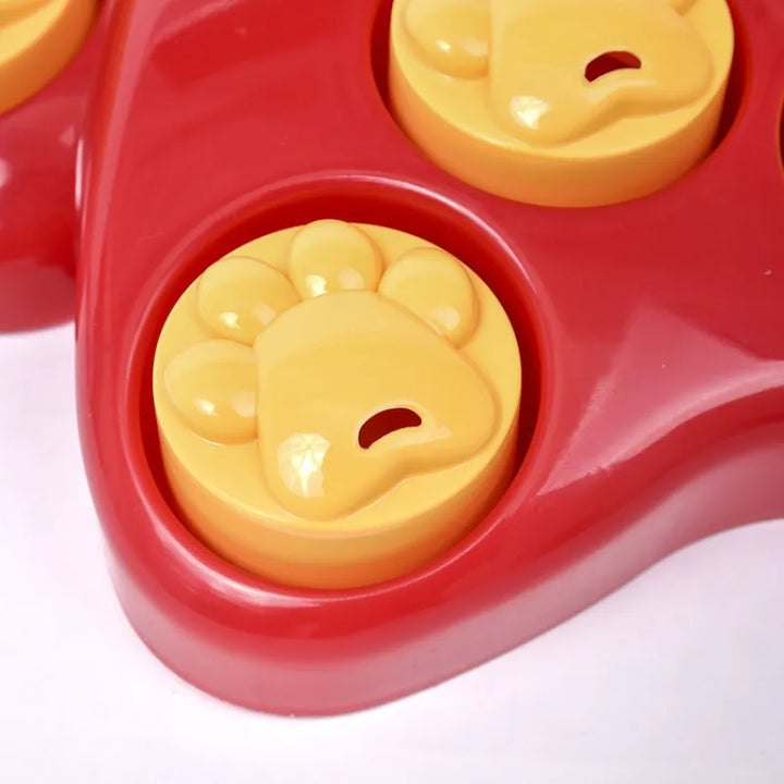 Red pet puzzle toy with paw designs, an engaging interactive feeder for dogs to slow eat