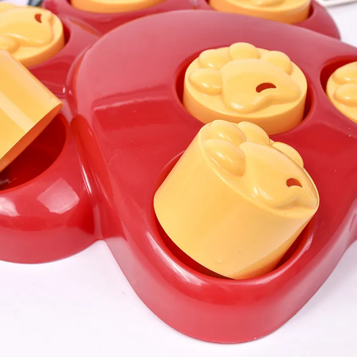 Overhead view of a red dog paw design interactive feeder, a great pet supply for slow eating