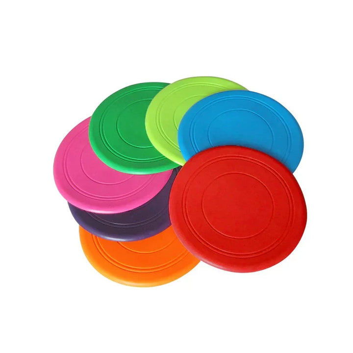 Green durable dog frisbee on a sandy beach, perfect for active outdoor pet entertainment.
