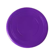 Dog happily catching a green durable frisbee mid-air, showcasing active fetch fun.