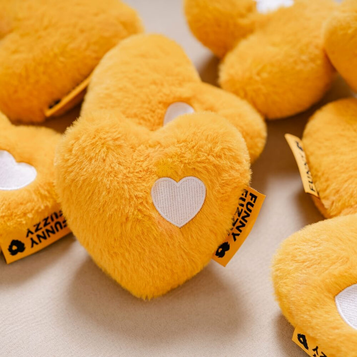 Interactive heart comfort toy for pets, featuring a squeaker inside, great for chewing and cuddling.