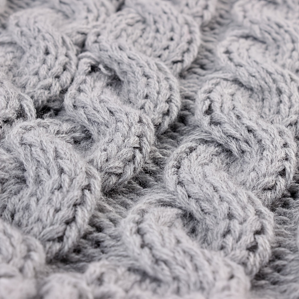 Close-up of the knit texture of a warm dog sweater, soft acrylic pet pullover.
