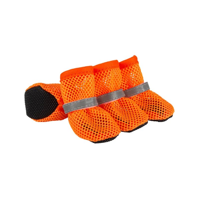 Medium-sized dog's paw visible inside a camouflaged dog shoe, emphasizing secure fit and paw protection.
