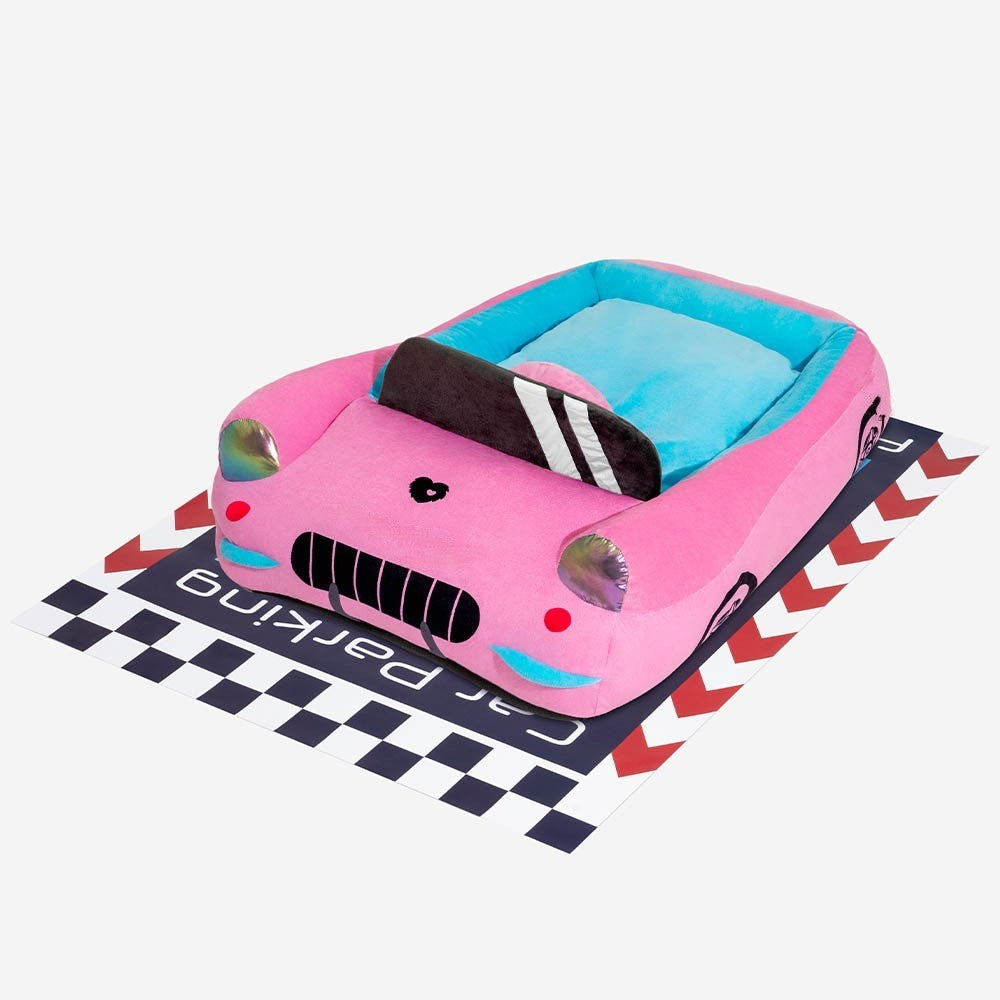 Detailed view of a soft red race car pet bed, showcasing the bolster and plush interior.