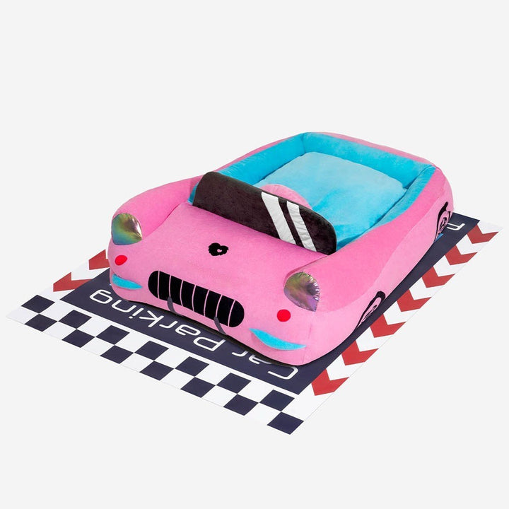 Detailed view of a soft red race car pet bed, showcasing the bolster and plush interior.