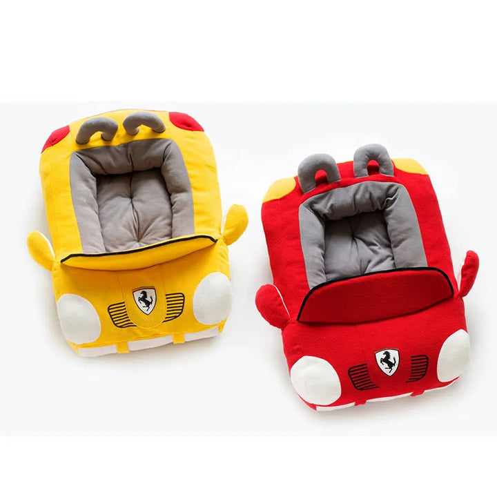 Puppy sleeping soundly in a vibrant red sports car shaped dog bed