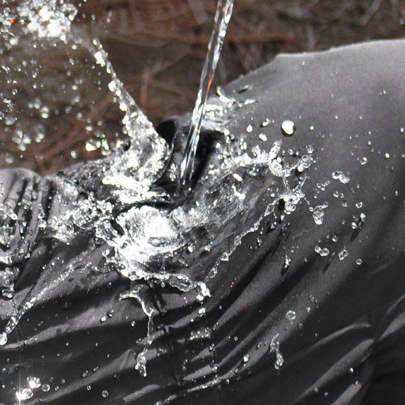Close-up of the breathable fabric on the black waterproof dog coat, pet apparel detail.