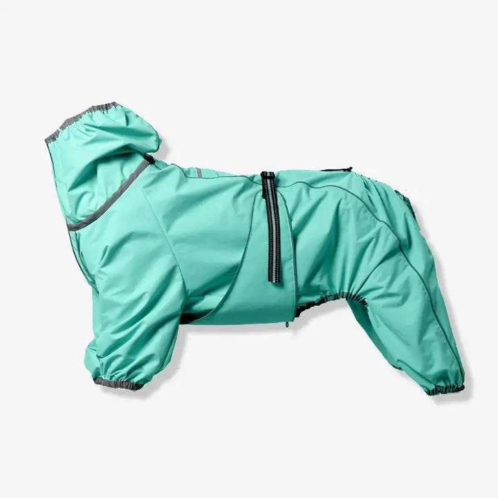 Dog wearing an orange reflective waterproof pet jacket, standing in a grassy outdoor area.