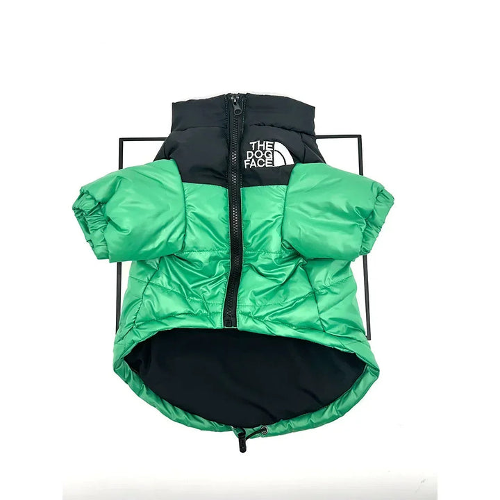 Close-up of a warm insulated dog coat, red with reflective trim, designed for cold weather.