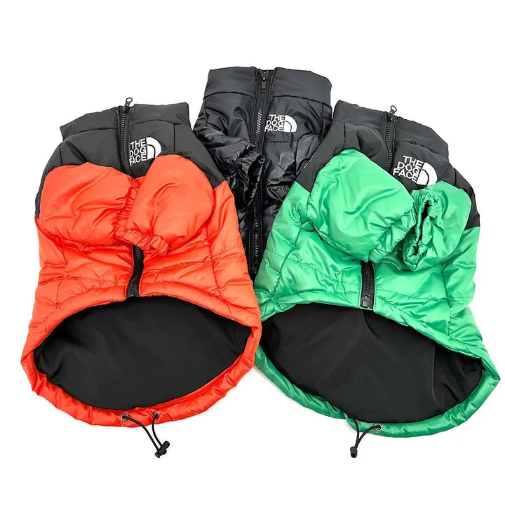 Red windproof dog jacket, insulated & waterproof, laid flat to show its robust design for pets.