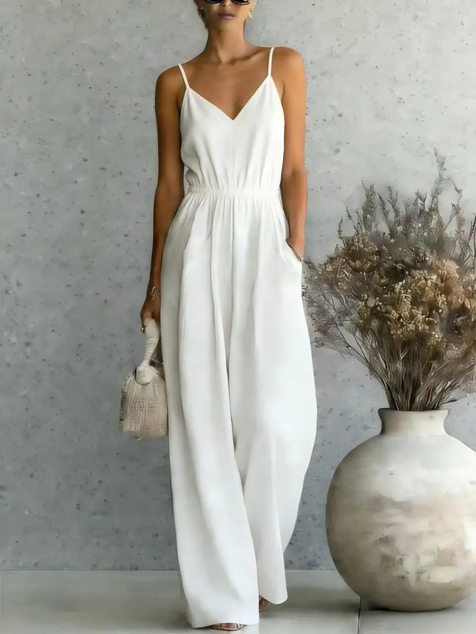 Relaxed fit women's sleeveless V-neck wide leg jumpsuit. Ideal for casual summer fashion & vacation wear.