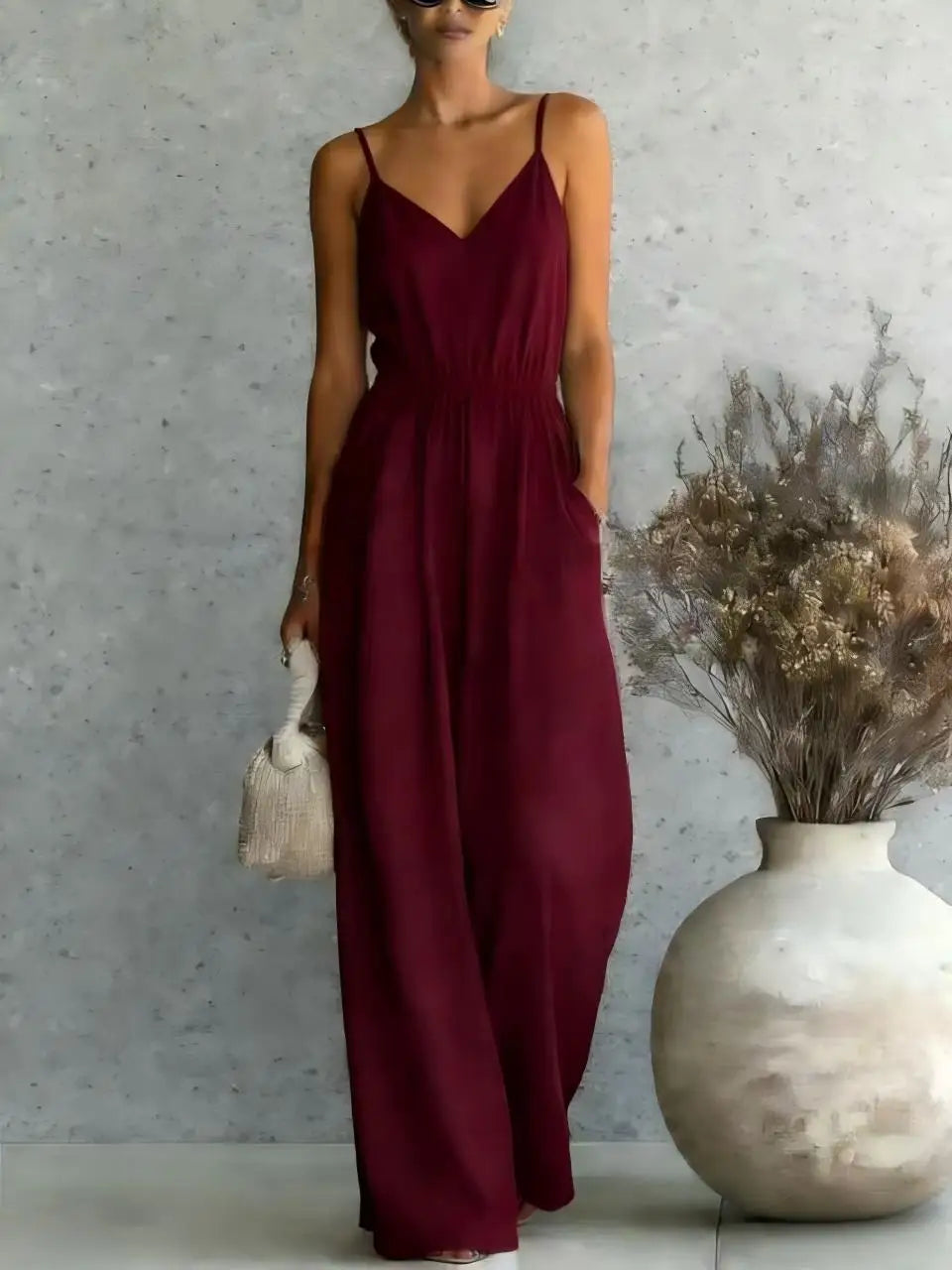 Women's casual V-neck jumpsuit featuring wide legs and a sleeveless cut. Great for summer fashion & vacations.