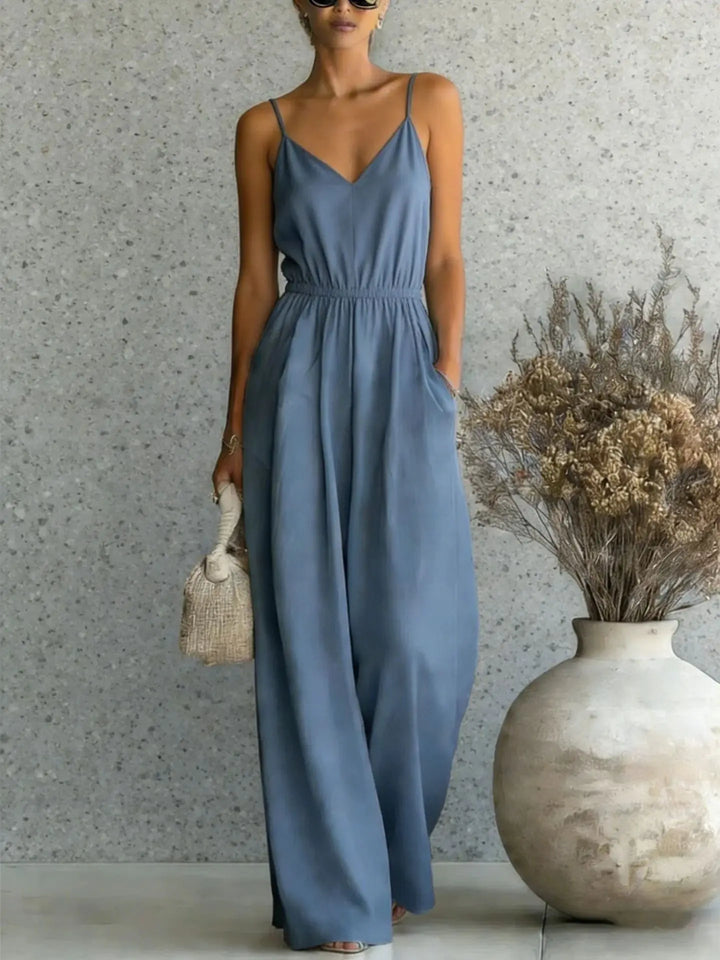 Model wearing a women's V-neck wide leg jumpsuit, perfect for relaxed summer outfits & vacation wear.
