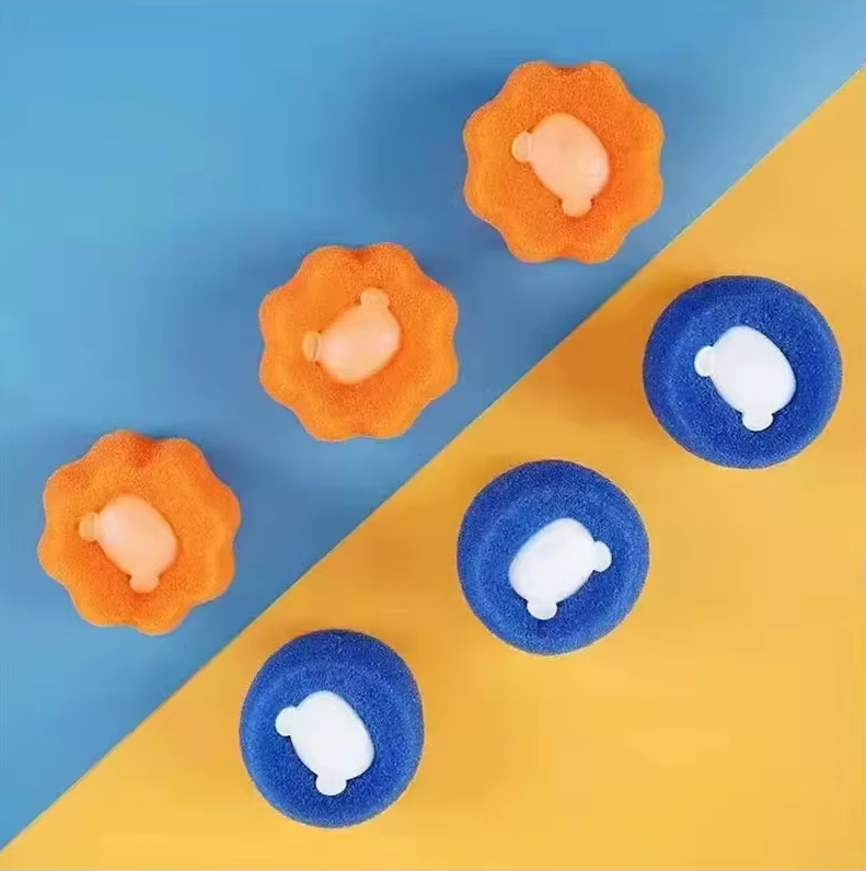 Hand holding a soft, spiky dryer ball, designed to catch pet hair and lint in laundry.