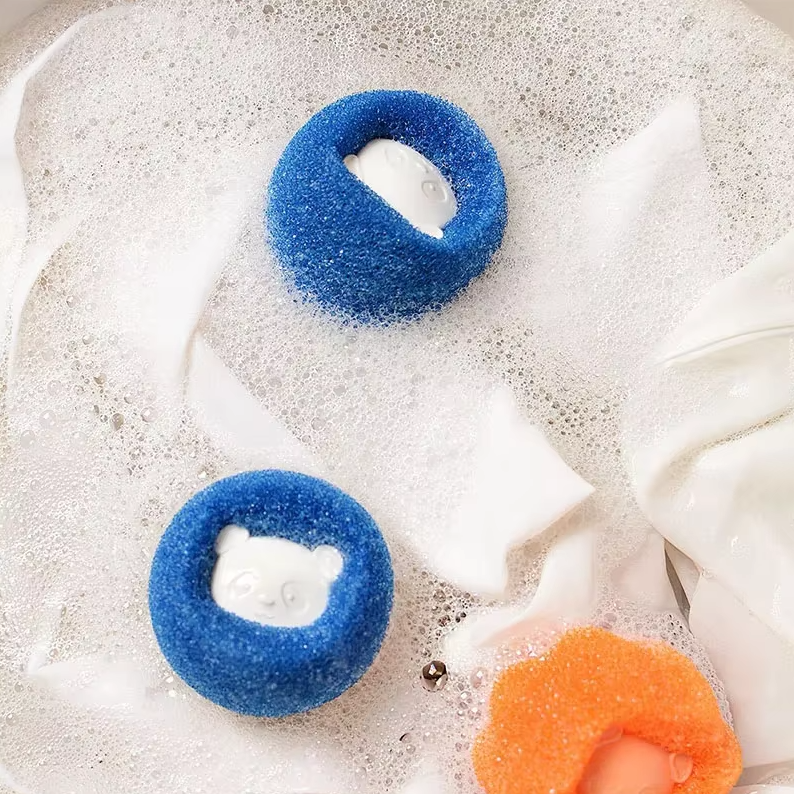 Dryer balls tumbling with clothes, reducing pet hair and softening fabrics naturally.