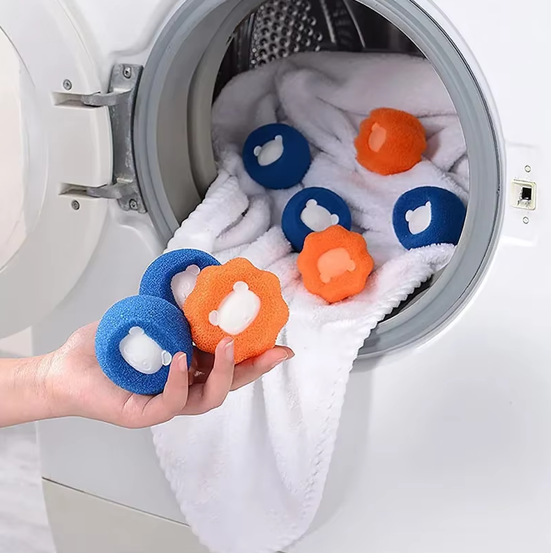 A pile of clean, lint-free clothes, achieved using pet hair remover dryer balls.