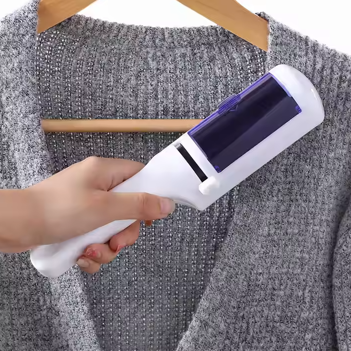 Compact pet hair and lint remover tool picks up fur from dark blue clothing, eco-friendly design.
