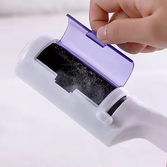 Close-up of pet hair remover demonstrating its effective lint and fur removal on black pants.