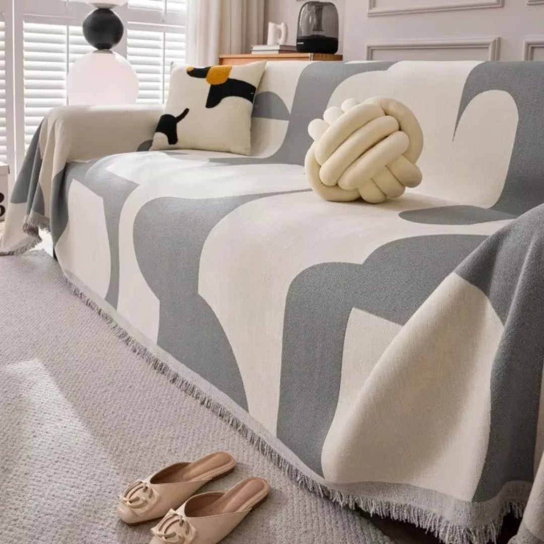 Textured chenille sofa cover designed for durability, protecting furniture with its reversible design and stylish tassels.