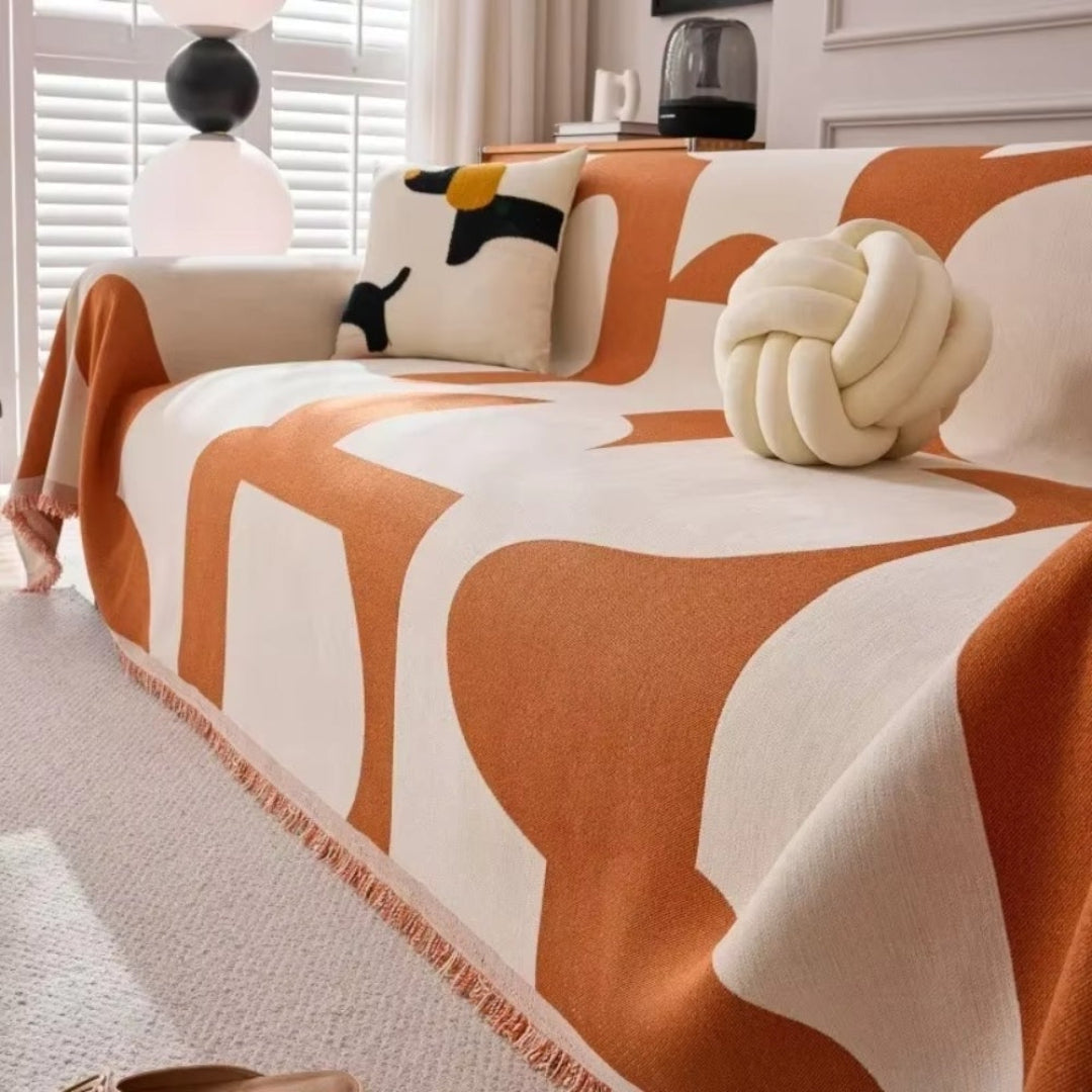 Cozy chenille sofa protector with fringe tassels, offering a pet-friendly and easy-care solution for home interiors.