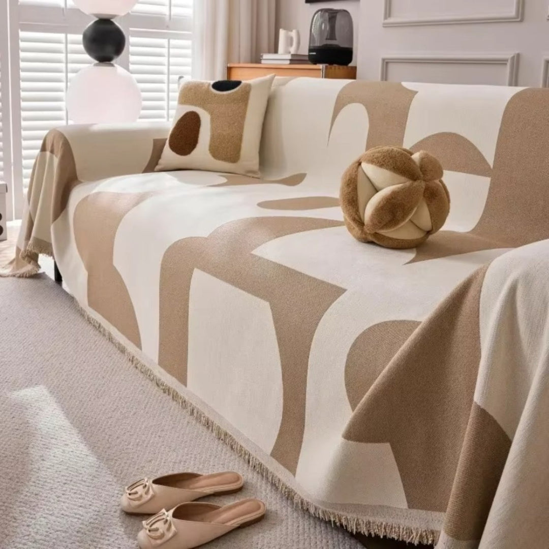 Chenille furniture slipcover with long tassels, providing robust protection and a charming aesthetic for any sofa.