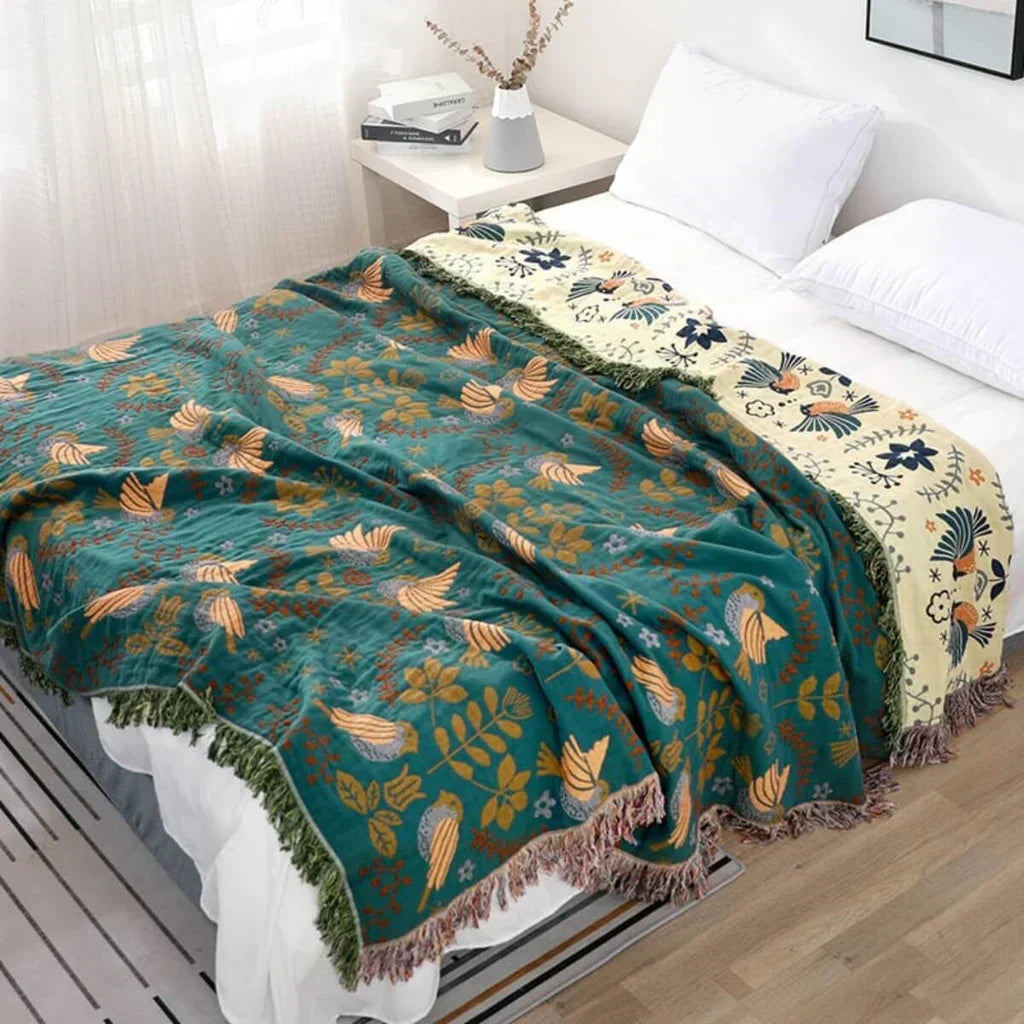 Reversible Scandinavian bird pattern cotton blanket for cozy home decor. Unisex throw with unique design.