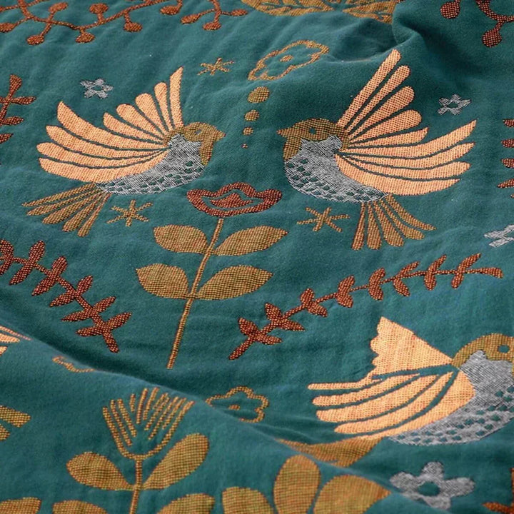 Decorative accent throw blanket featuring a unique reversible Scandinavian bird design for living room comfort.