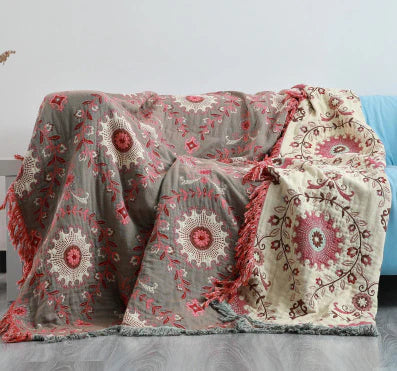 Versatile reversible cotton blanket with charming Scandinavian bird design, ideal for home or picnic use.