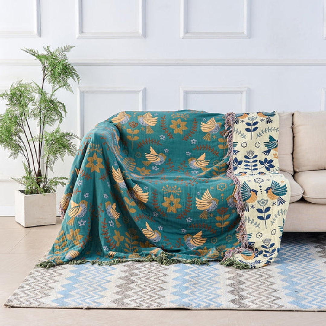 Woven throw blanket, featuring a reversible bird pattern in a traditional Scandinavian design.