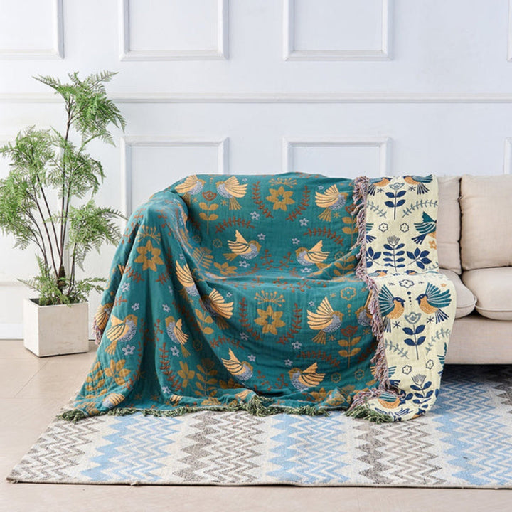 Woven throw blanket, featuring a reversible bird pattern in a traditional Scandinavian design.